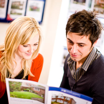 man and woman reading a leaflet