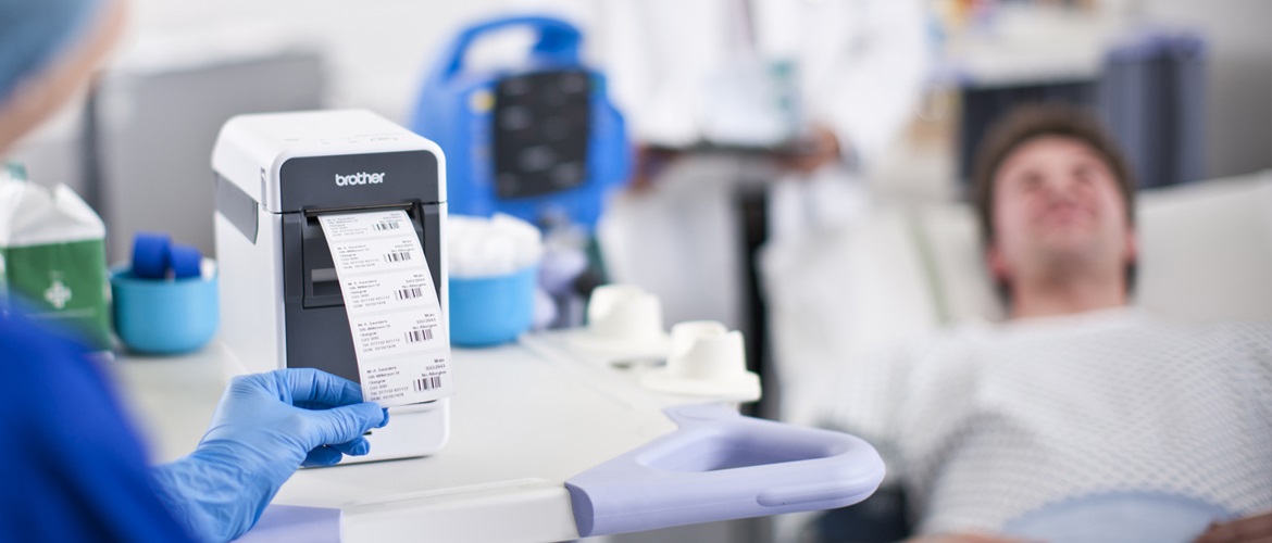 Nurse printing labels bedside