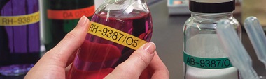 Bottles containing chemicals being labelled with Brother P-touch TZe labels