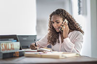 A woman with long hair talks on the phone